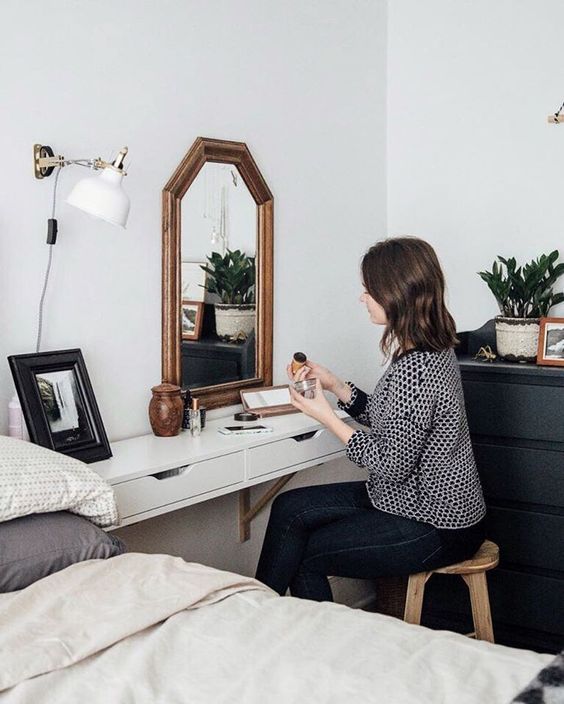 a floating bedside table that doubles as a vanity and has two drawers