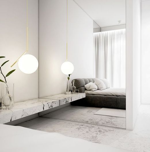 a mirror wall is used to make the laconic bedroom more interesting