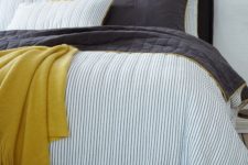 21 blue thin striped bedding with black and mustard touches for a bolder look