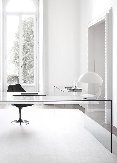 laconic masculine home office needs no more than an L-shaped clear glass desk