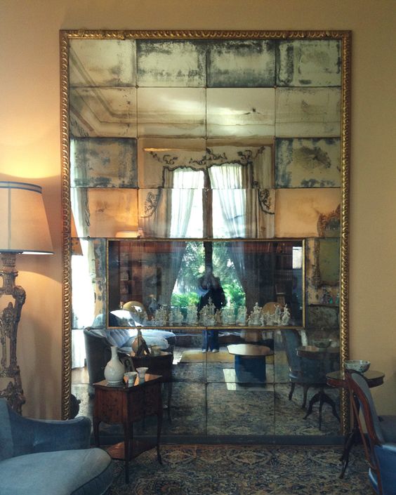 add a large antique mirror in a gilded refined frame to make your traditional room really tasteful