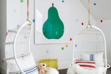 22 colorful polka dot wall decor, a bold fruit wall art and cool hanging chair make the nook super inviting