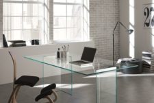 22 minimalist and industrial home office with a clear glass desk and an eye-catching upholstered chair