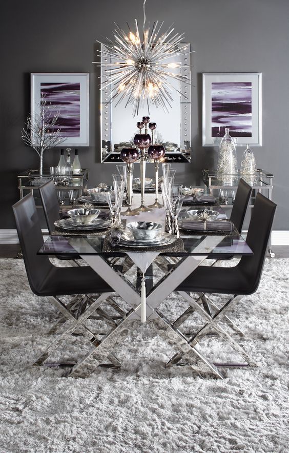 a chic table with criss cross metal legs and matching chairs in black for a dramatic dining space