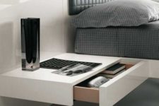 23 a minimalist white bedside table with a drawer is all you need