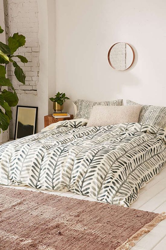 boho and mid-century modern bedding with a muted green botanical print