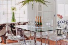 24 a dining table with metal legs and acrylic chairs on the same legs look modern, chic and ethereal