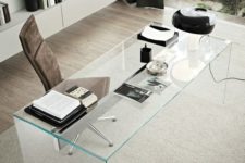 24 a masculine home office is made cooler with a clear glass desk, it brigns an edgy look