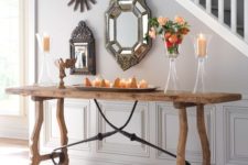 24 a rustic trestle console table with blackened metal decor echoes with vintage metal framed mirrors