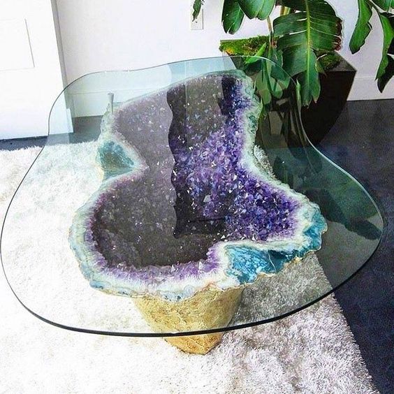 a unique coffee table with an amethyst base gilded on the outside and a matching in shape glass tabletop will be a showstopper