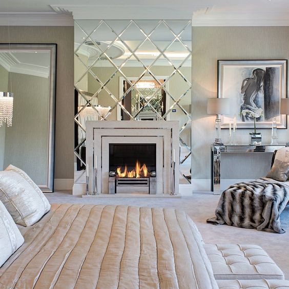 a large geo mirror accent for the fireplace looks shiny and glam