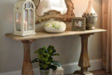 25 a small trestle table used as a console for a vintage-inspired entryway