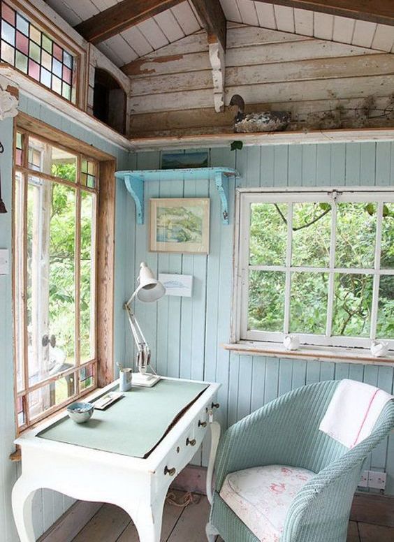 aqua and turquoise colored home office in a she shed looks cozy and cute
