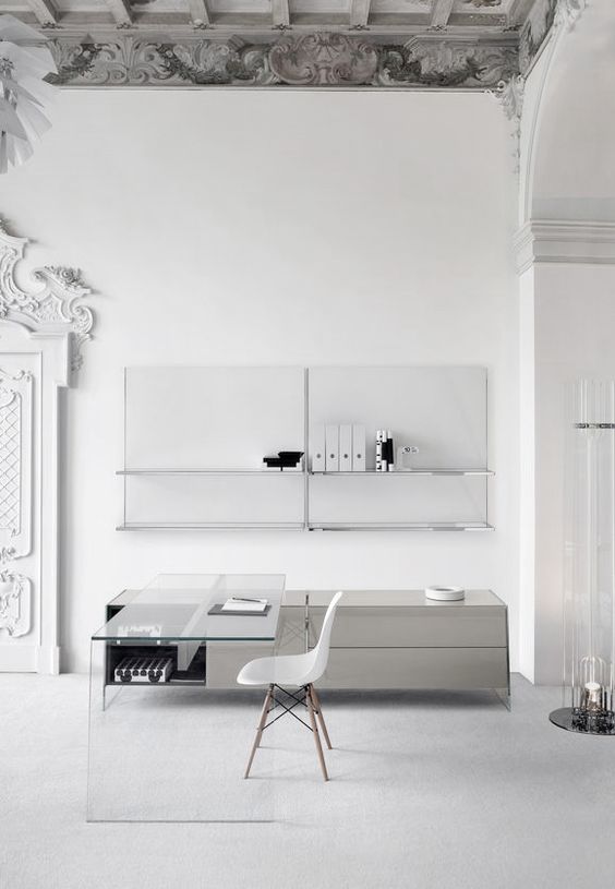 clear glass desk in an ultra-minimalist white and grey home office