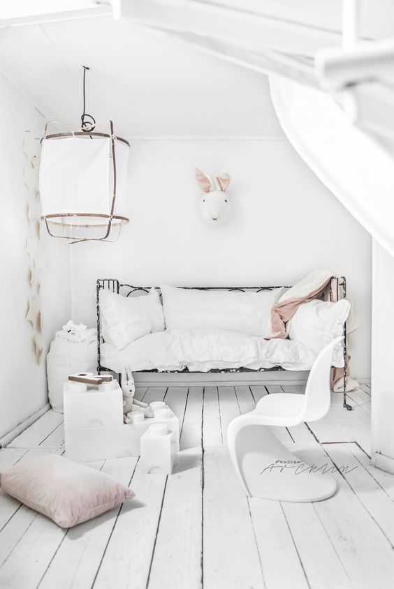 Nordic-inspired kids' room with a toy rabbit head and stars on the wall