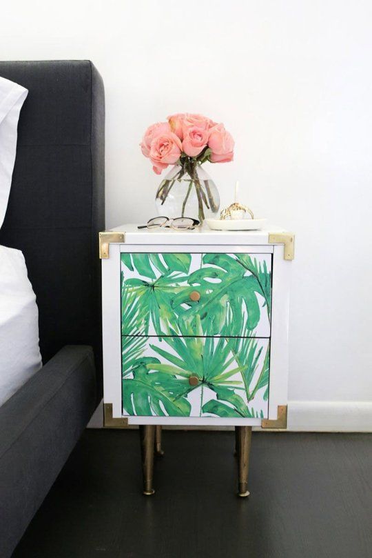 a tropical leaf nightstand with chic metallic touches