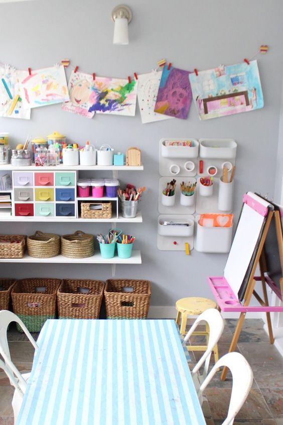 display children's art pieces on the wall to make them proud