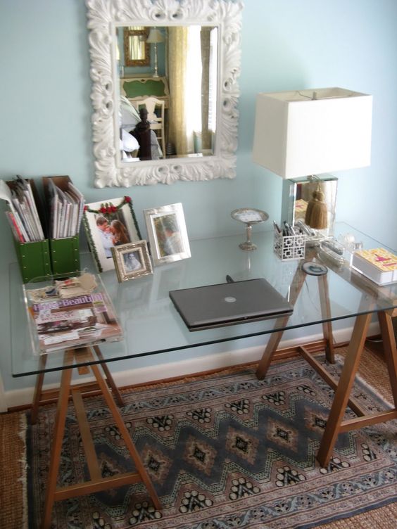a combo of stained wooden trestle legs and a glass tabletop can be a nice refreshing idea for a rustic home office