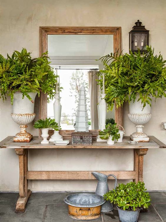A trestle table used as a console in a shabby chic entryway   such a cozy and comfy in using piece
