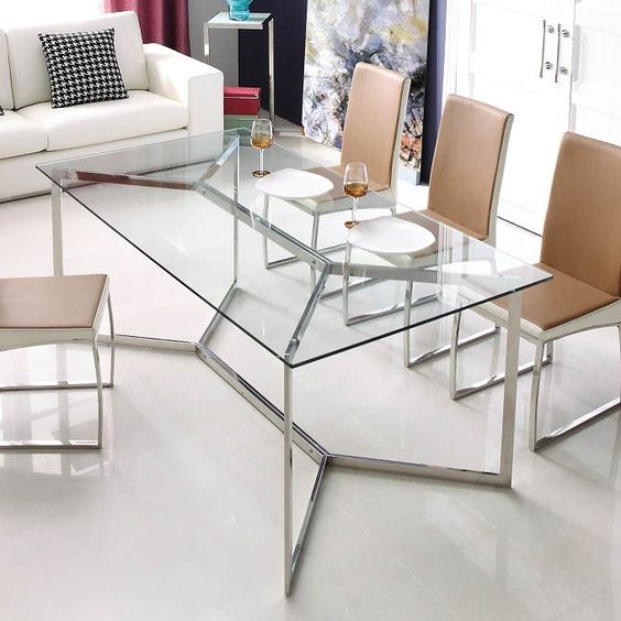 a chic and edgy dining table with a metal framing and a glass tabletop looks amazing