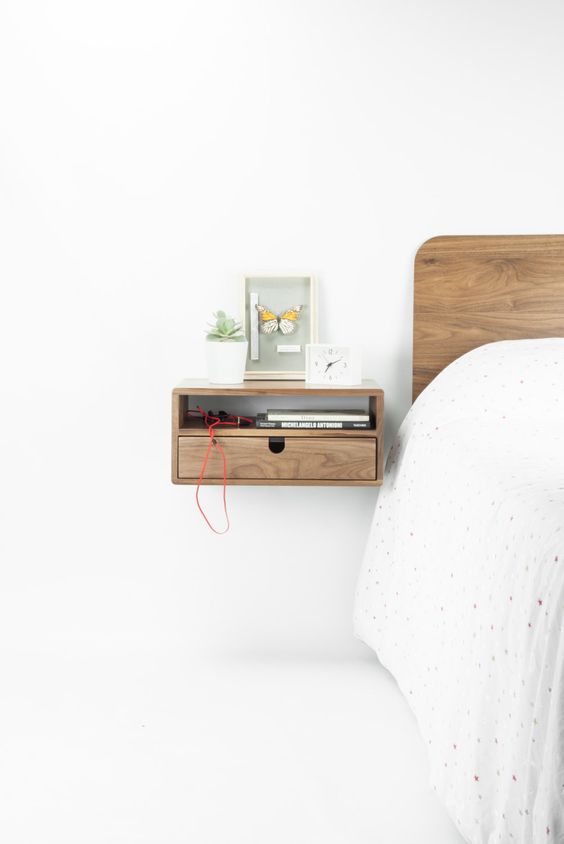 a tiny stylish wooden nightstand with an open storage space and a drawer