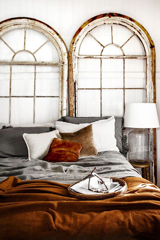 an amber velvet bedspread and a matching pillow add style to this shabby chic bedroom