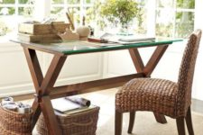 30 a rustic desk with dark stained wood trestle legs and a glass tabletop