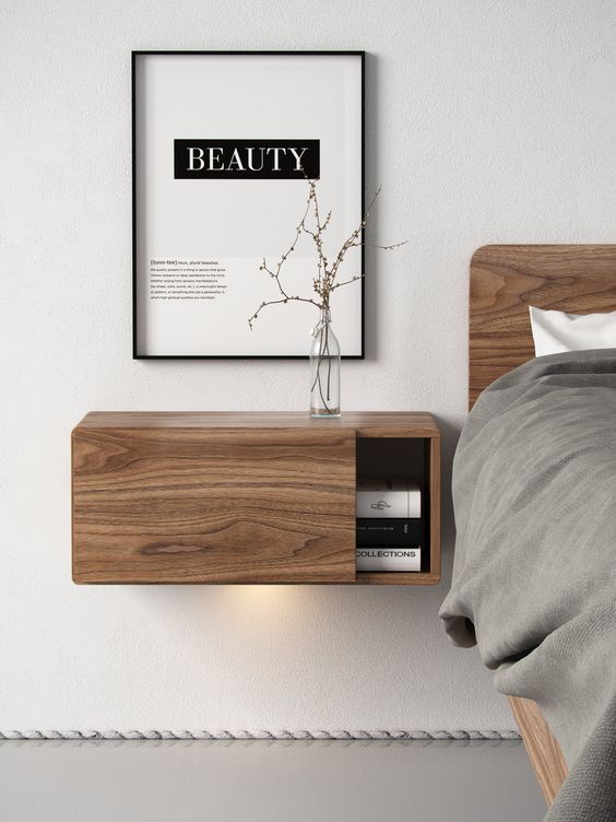a wooden floating nightstand with a sliding door for comfy storage