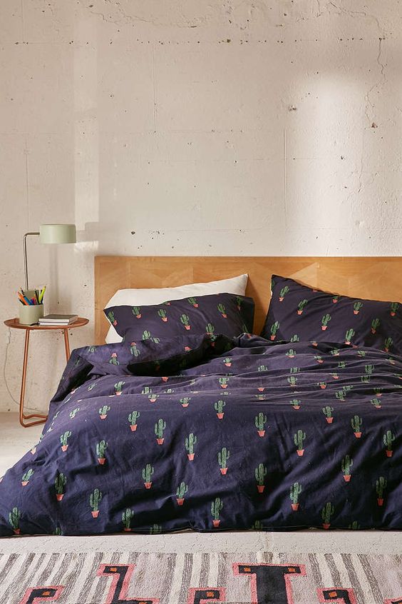 navy bedding set with a cactus print for a desert-inspired space