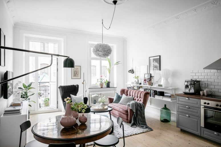 This Scandinavian apartment features beautiful historical elements and some pastel and muted touches here and there