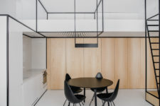 01 This modern apartment with a minimalist color palette features black framing, which adds functionality and ties up the decor