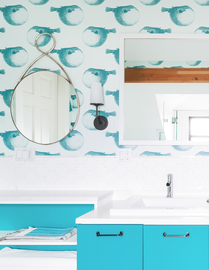 The blowfish wall covering sets the tone in this cheerful space