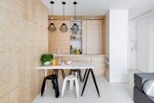 02 The kitchen is cla with wood panels like the most of the space, panels look sleek and modern