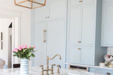 02 serenity blue kitchen cabinets with white marble countertops and brass touches for a retro look