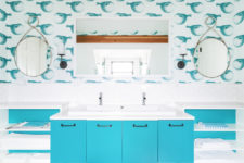 03 The bathrooms features a turquoise vanity with four compartments, open shelving on both sides and a large mirror
