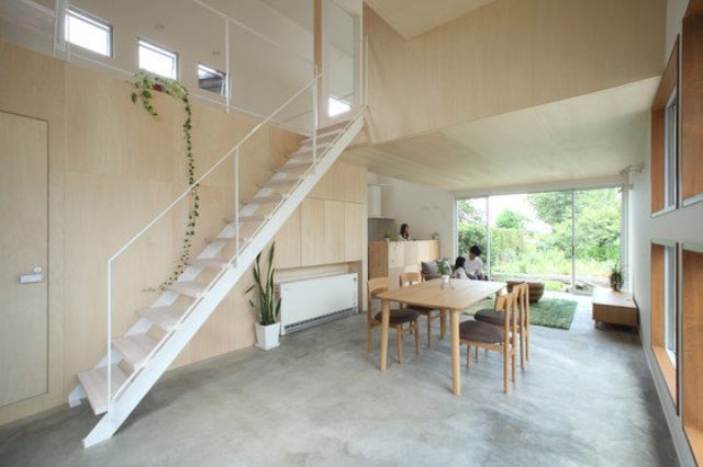 The dining space features a light-colored modern dining set, and there's a ladder going up to the next levels