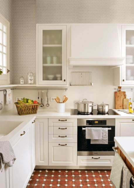 The kitchen features white cabinets and surfaces