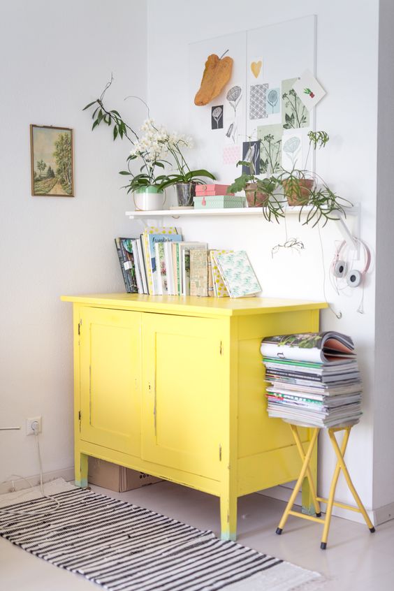 a neutral interior will play out in new shades with a sunny yellow sideboard and a stool
