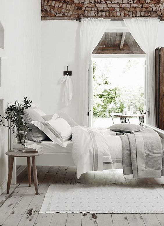 rough brick on the ceiling, white walls and whitewashed wooden floors, greys and white