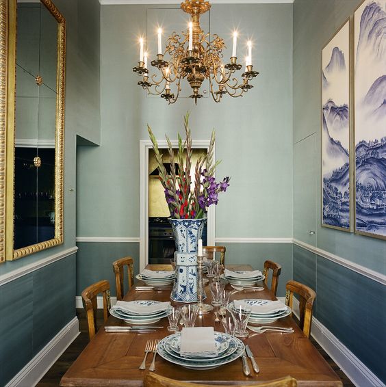 the dining room reminds of glaciers with greyish blue wallpaper and glacier artworks
