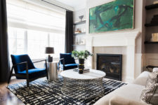 04 A fireplace, open shelving and lots of light make this living room ethereal, while a green artwork and cobalt blue chairs add color
