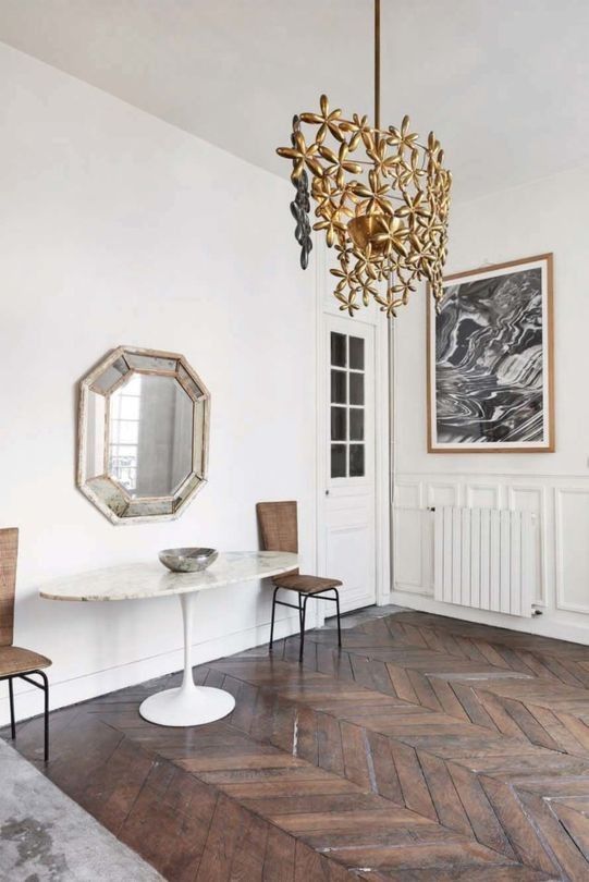 The home is filled with interesting items like this floral chandelier, a vintage mirror and many artworks