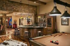 04 a man cave decorated in rustic style, with stone, wood and with faux animal skins