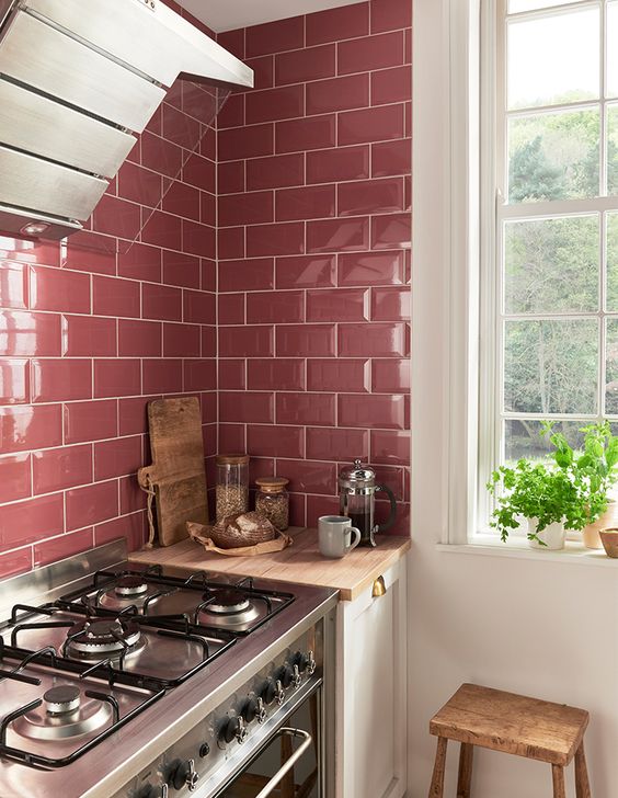 glossy pink tiles make up a cool backsplash for a girlish kitchen
