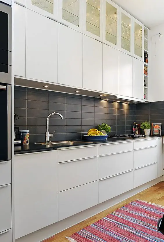 matte black rectangular tiles add texture to the kitchen decor