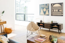 05 Tribal artworks and wicker chairs and a rough wood table add interest to the space