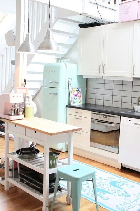a mint Smeg fridge and a matching stool for a small and cozy neutral kitchen