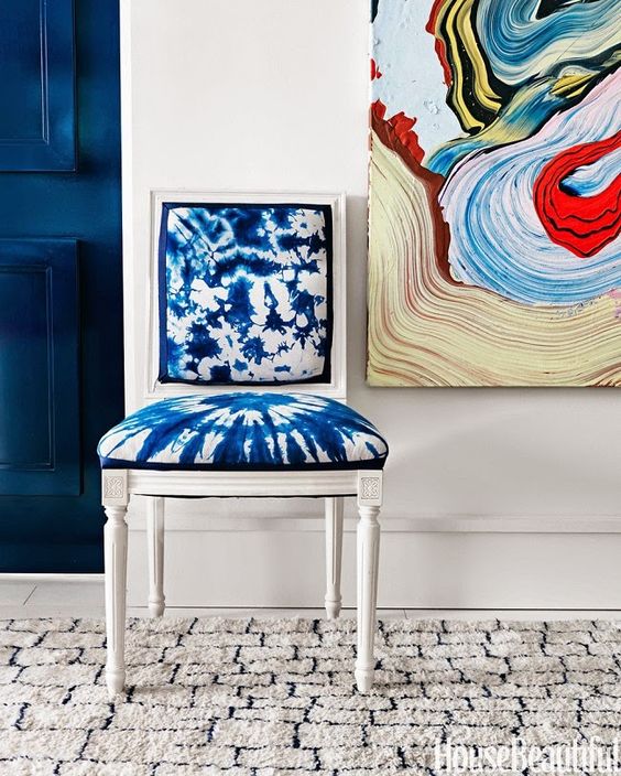 a vintage white chair is spruced up with shibori fabric and made cooler