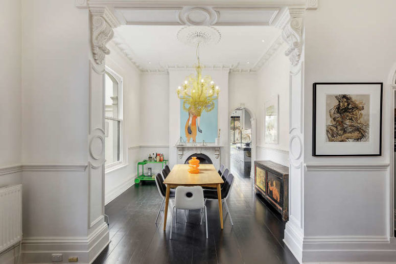 Here's a dining room with modern dinign furniture, an antique sideboard and a modern and bold chandelier