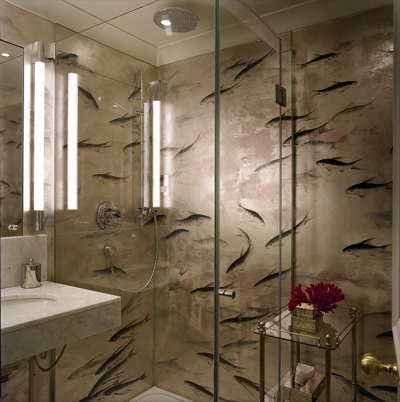 In the bathroom the fish print wallpaper is treated to resist moisture